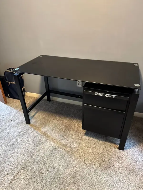 Used desk with a glass top, perfect for all those … puzzles. Two drawers: top drawer good for small items and larger bottom drawer can be used as a filing cabinet.

Good for a a monitor, keyboard and laptop.
