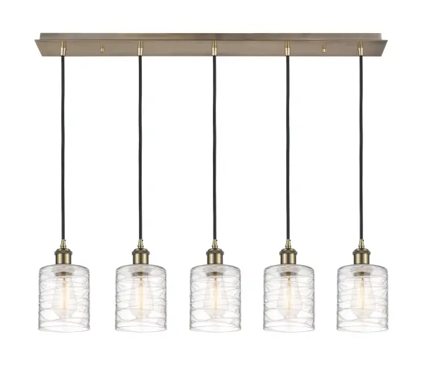 The organic teardrop shape of the Crown Point pendant is artfully hung from a tiered metal frame that is complemented by a single filament bulb. These pendants look great as individual fixtures but make a grand statement when paired with our multi-port hanging system as part of our custom cord program.