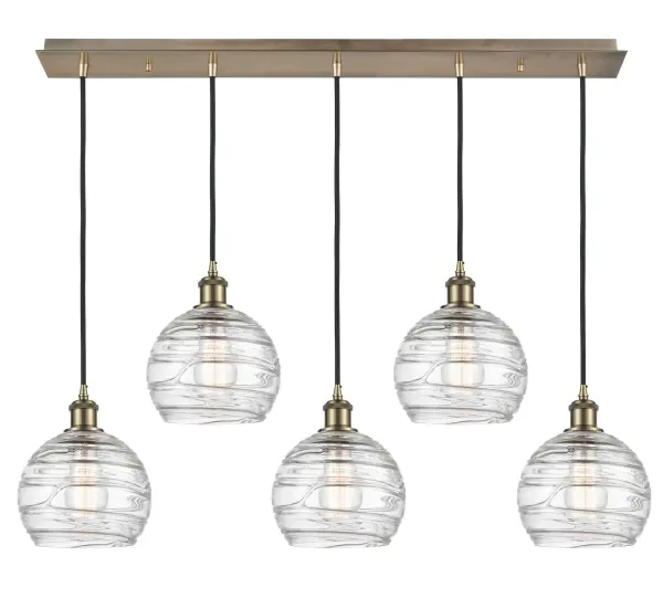 The organic teardrop shape of the Crown Point pendant is artfully hung from a tiered metal frame that is complemented by a single filament bulb. These pendants look great as individual fixtures but make a grand statement when paired with our multi-port hanging system as part of our custom cord program.