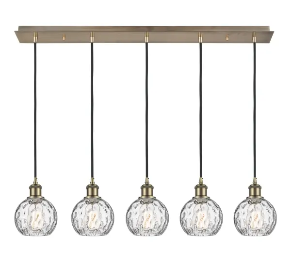The organic teardrop shape of the Crown Point pendant is artfully hung from a tiered metal frame that is complemented by a single filament bulb. These pendants look great as individual fixtures but make a grand statement when paired with our multi-port hanging system as part of our custom cord program.