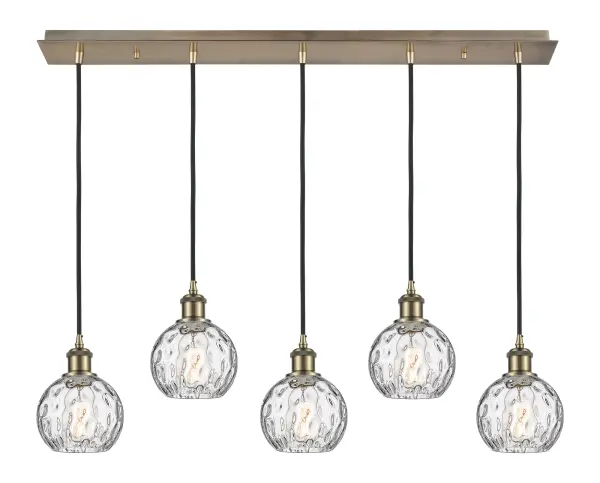 The organic teardrop shape of the Crown Point pendant is artfully hung from a tiered metal frame that is complemented by a single filament bulb. These pendants look great as individual fixtures but make a grand statement when paired with our multi-port hanging system as part of our custom cord program. - alternate view