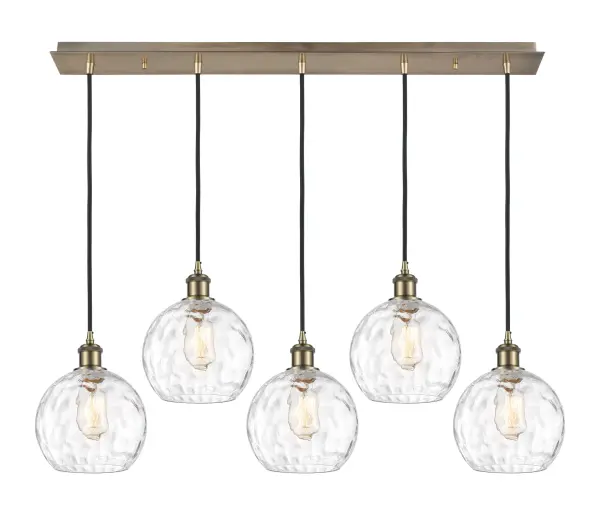 The organic teardrop shape of the Crown Point pendant is artfully hung from a tiered metal frame that is complemented by a single filament bulb. These pendants look great as individual fixtures but make a grand statement when paired with our multi-port hanging system as part of our custom cord program.