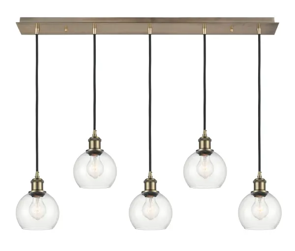 The organic teardrop shape of the Crown Point pendant is artfully hung from a tiered metal frame that is complemented by a single filament bulb. These pendants look great as individual fixtures but make a grand statement when paired with our multi-port hanging system as part of our custom cord program. - alternate view