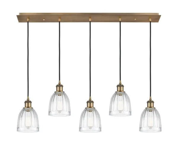 The organic teardrop shape of the Crown Point pendant is artfully hung from a tiered metal frame that is complemented by a single filament bulb. These pendants look great as individual fixtures but make a grand statement when paired with our multi-port hanging system as part of our custom cord program. - alternate view