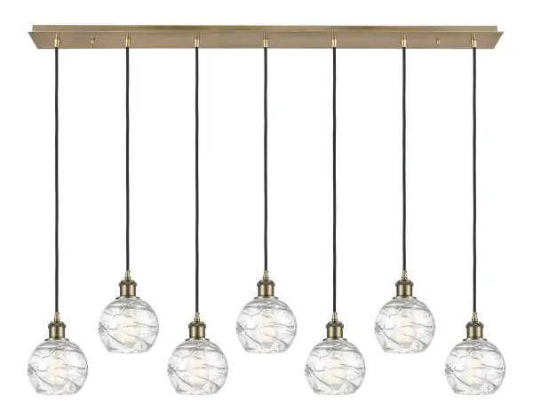 The organic teardrop shape of the Crown Point pendant is artfully hung from a tiered metal frame that is complemented by a single filament bulb. These pendants look great as individual fixtures but make a grand statement when paired with our multi-port hanging system as part of our custom cord program. - alternate view