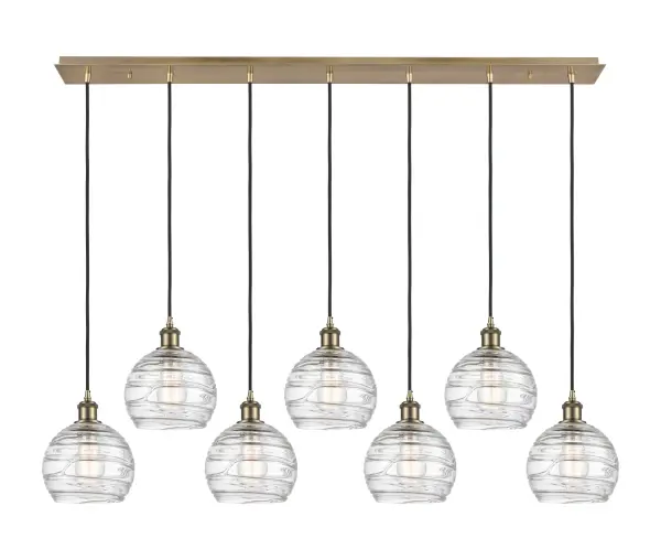 The organic teardrop shape of the Crown Point pendant is artfully hung from a tiered metal frame that is complemented by a single filament bulb. These pendants look great as individual fixtures but make a grand statement when paired with our multi-port hanging system as part of our custom cord program.