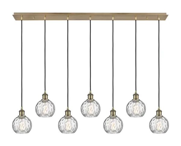 The organic teardrop shape of the Crown Point pendant is artfully hung from a tiered metal frame that is complemented by a single filament bulb. These pendants look great as individual fixtures but make a grand statement when paired with our multi-port hanging system as part of our custom cord program. - alternate view