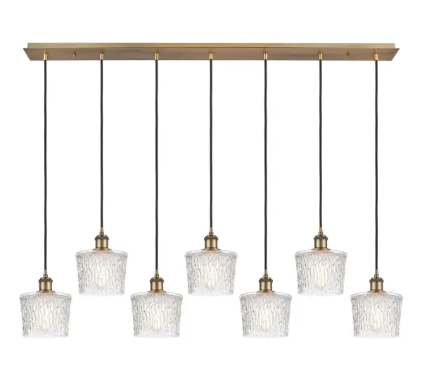 The organic teardrop shape of the Crown Point pendant is artfully hung from a tiered metal frame that is complemented by a single filament bulb. These pendants look great as individual fixtures but make a grand statement when paired with our multi-port hanging system as part of our custom cord program. - alternate view
