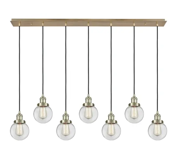 The organic teardrop shape of the Crown Point pendant is artfully hung from a tiered metal frame that is complemented by a single filament bulb. These pendants look great as individual fixtures but make a grand statement when paired with our multi-port hanging system as part of our custom cord program. - alternate view