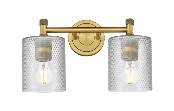 Details abound in the Crown Point Collection with an industrial take on modern sophistication. This stunning line of fixtures features cylindrical glass set in an updated restoration style frame with intricate knurling detail on the sockets, canopy, and finials.