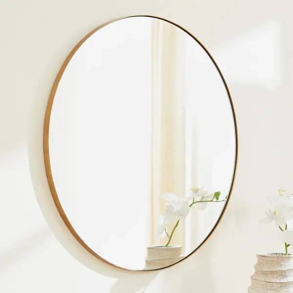 A clean and simple 30-inch round mirror with a gold finish that brings warmth and elegance to any room. Its versatile design works seamlessly across multiple décor styles from modern to transitional. - alternate view