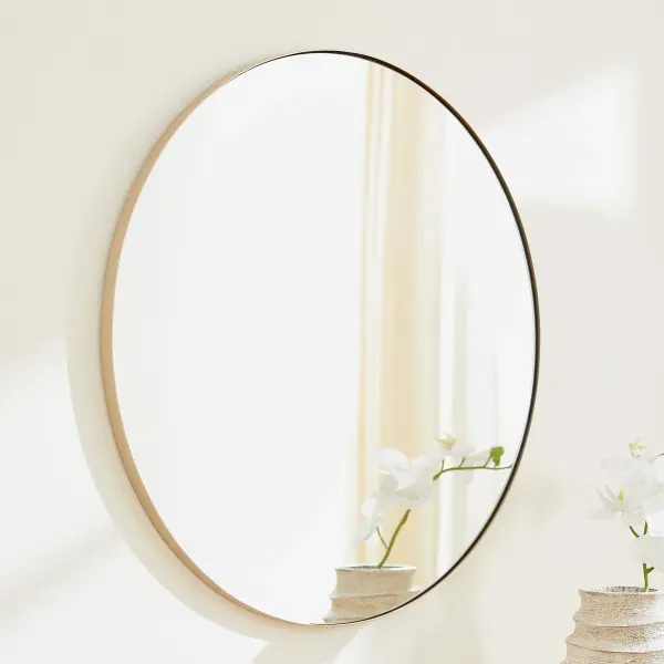 A classic 30-inch round mirror with a sleek silver frame that complements any décor style. Its clean lines and simple design make it a versatile choice for residential and commercial spaces alike. - alternate view