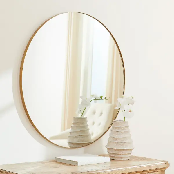 A clean and simple 42-inch round mirror with a gold finish that brings warmth and sophistication to any space. Its generous size makes it ideal for bathrooms, bedrooms, and entryways while maintaining a timeless aesthetic. - alternate view