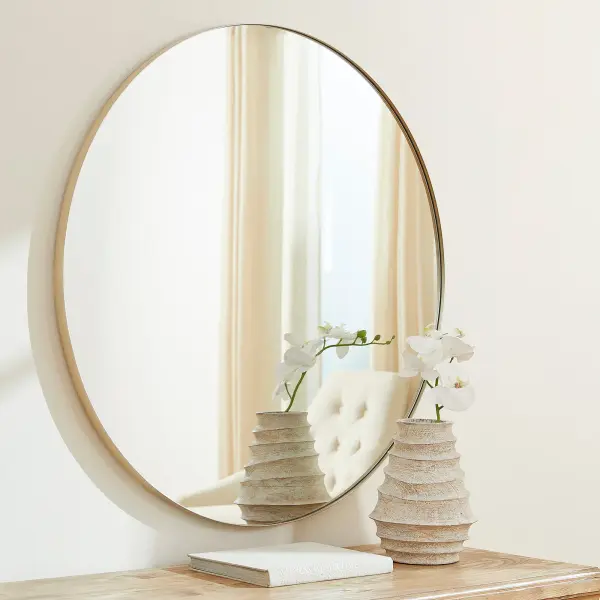 This 42-inch round mirror features a sleek silver finish that complements any décor style. Its generous size makes it ideal for bathrooms, bedrooms, and entryways, while the simple, clean design ensures timeless appeal. - alternate view