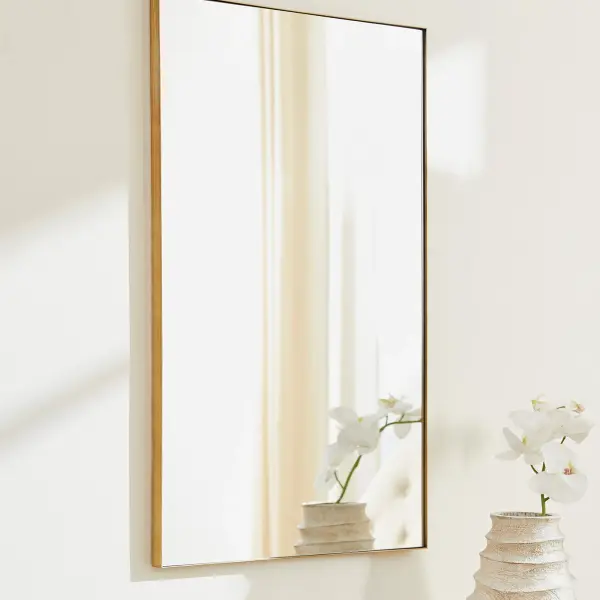 A simple yet elegant 24x36" rectangular mirror featuring a warm gold frame. Its clean lines and classic proportions make it adaptable to various décor styles, from contemporary to transitional spaces. - alternate view