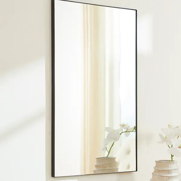 This 24x36" rectangular mirror features a sleek matte black frame that complements any contemporary or minimalist décor. Its versatile size and clean lines make it ideal for bathrooms, bedrooms, and entryways. - alternate view