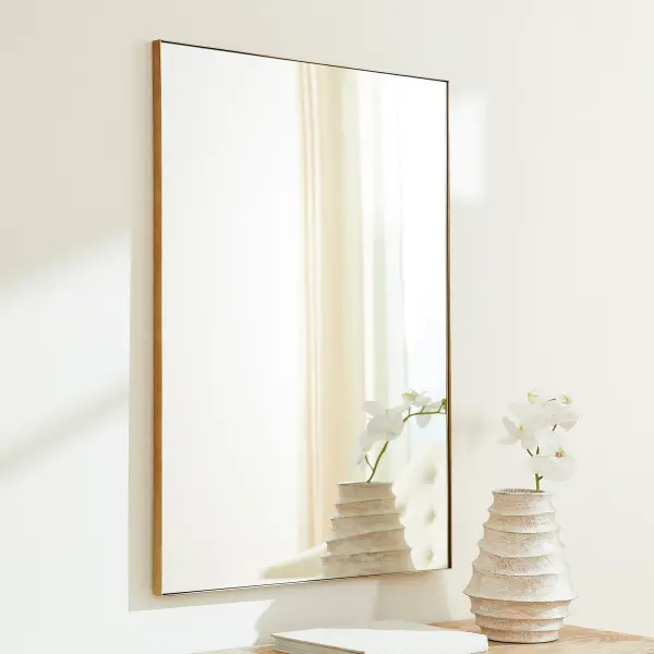 This 30x40" rectangular mirror features a clean gold frame that adds warmth and elegance to any room. Its generous size and simple design make it ideal for bathrooms, bedrooms, and entryways, complementing both contemporary and transitional décor. - alternate view