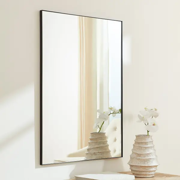 This 30x40" rectangular mirror combines clean lines with a sophisticated matte black finish, offering versatile styling for contemporary and minimalist interiors. The generous size provides excellent functionality while the simple frame design complements any décor. - alternate view