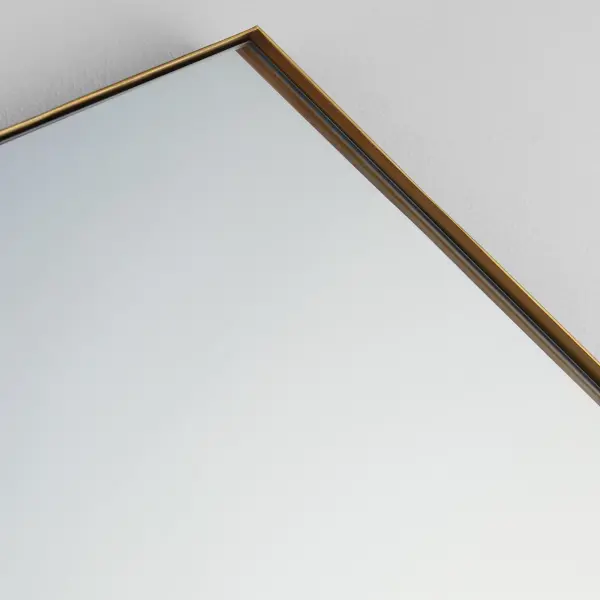 This 24"x34" hexagonal mirror combines contemporary geometric styling with practical functionality. The 1-inch frame extension in gold finish adds dimension while maintaining versatility across interior styles. - alternate view