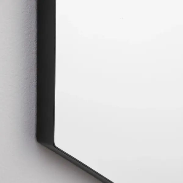 This 28x40 hexagonal mirror brings contemporary geometric style to any space with its distinctive shape and sleek matte black frame. The 1-inch frame extension adds depth and dimension while remaining versatile enough for residential and commercial applications. - alternate view
