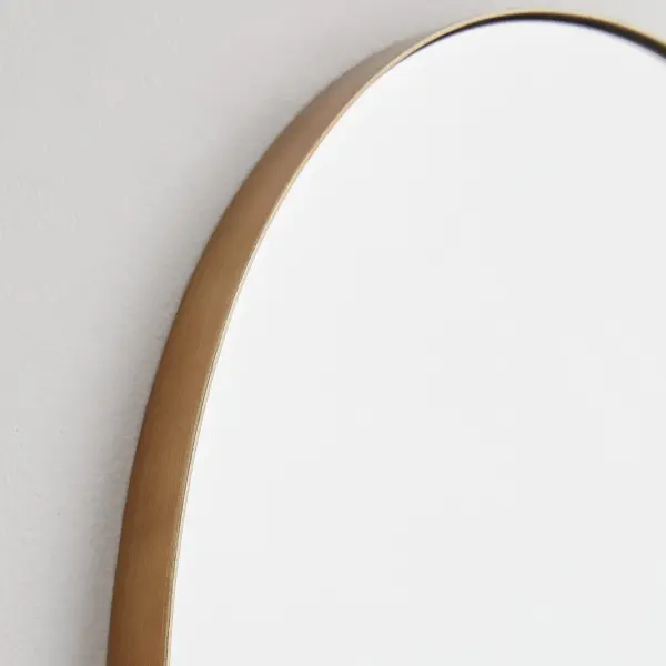 This 24x38 inch arched mirror combines classic arch styling with a modern gold finish. The 1-inch frame extension adds subtle depth while the versatile design works across multiple interior styles and spaces. - alternate view