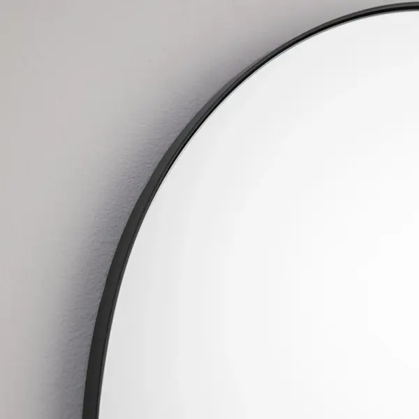 This 24x38 inch arched mirror combines timeless design with contemporary styling. The matte black finish and 1-inch frame extension create visual depth while remaining versatile enough for various interior styles. - alternate view