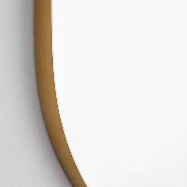 The Capsule mirror brings contemporary elegance with its distinctive pill-shaped contour and 1-inch extension frame. The matte gold finish adds warmth while maintaining a modern aesthetic, perfect for bathrooms and entryways. - alternate view