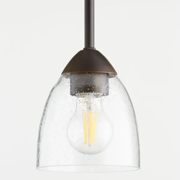 The Barkley mini pendant features clean-lined tube frames with organic forms that bridge traditional and contemporary styles. Its oiled bronze finish and clear seeded glass create visual interest while maintaining design versatility. - alternate view