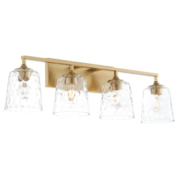 The Eldorado 4-Light Vanity combines clean lines with traditional bobeches in a warm aged brass finish. Frosted glass shades provide even, flattering illumination perfect for bathroom vanities and grooming areas. - alternate view