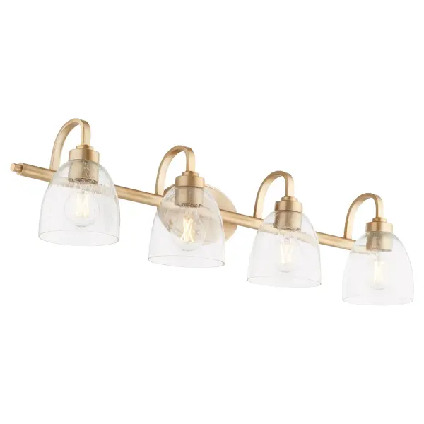 The Reyes 4-light vanity combines clean-lined elegance with transitional versatility. Its aged brass finish and clear seeded glass shades create sophisticated bathroom lighting that complements both traditional and contemporary spaces. - alternate view