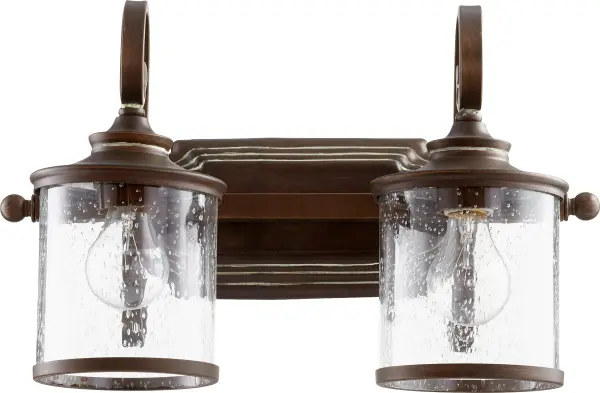 The San Miguel 2-Light Vanity brings sophisticated elegance to bathroom spaces with its beautifully curved candelabra arms and clear crystal accents. The vintage copper finish adds warmth while the transitional design bridges traditional and contemporary styles.