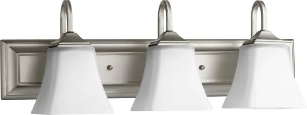 This 3-light vanity fixture combines a sleek rectangular backplate with soft bell-shaped satin opal glass shades, delivering balanced illumination perfect for bathroom grooming tasks while complementing both traditional and modern décor.