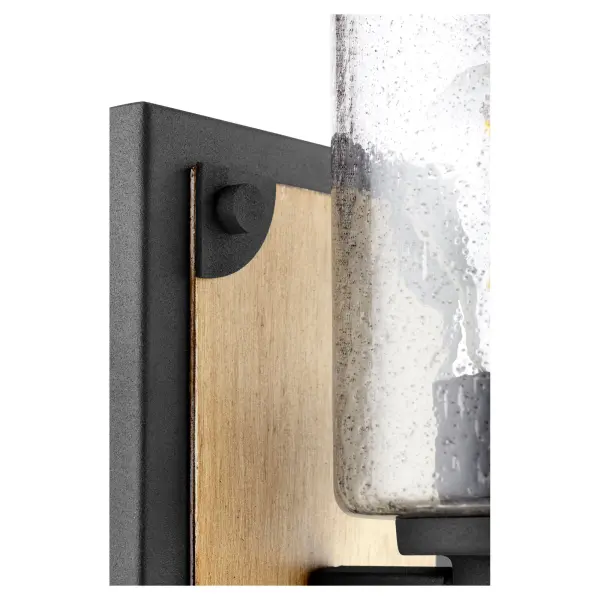 This single-light wall sconce combines industrial and farmhouse aesthetics with a distinctive upward-facing design. The two-toned driftwood and noir finish paired with clear seeded glass creates authentic character and vintage appeal. - alternate view