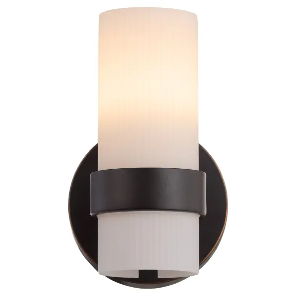The Sojourn wall sconce masterfully blends contemporary design with nostalgic charm, featuring a distinctive white milky glass pillar and modern bobeche detail. Its bronze finish and candle-inspired aesthetic bring refined character to any space. - alternate view
