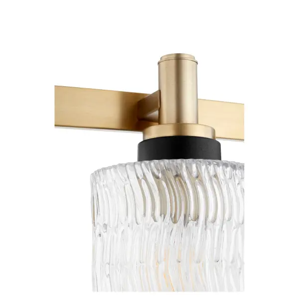 The Stadium vanity light delivers timeless elegance with modern versatility. Featuring an Aged Brass finish and clear chiseled glass shades, this 4-light fixture offers sophisticated illumination for any bathroom. Unique customizable socket accessories in three finishes allow personalization to match your décor perfectly. - alternate view