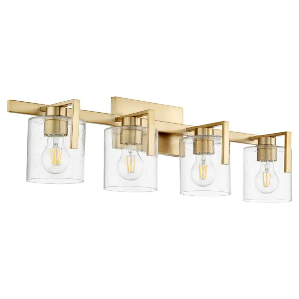 This four-light vanity fixture combines classic seeded glass shades with warm aged brass for a sophisticated bathroom lighting solution. The rectangular backplate and round shades create visual interest while providing ample illumination.