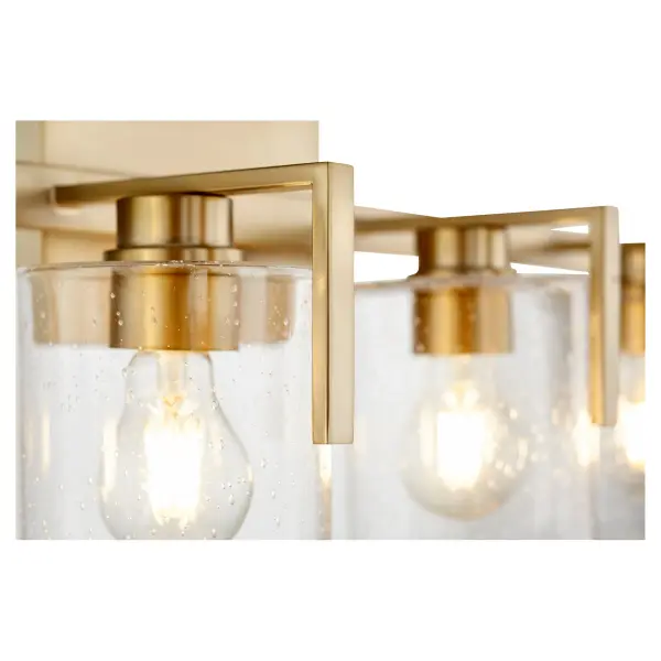 This four-light vanity fixture combines classic seeded glass shades with warm aged brass for a sophisticated bathroom lighting solution. The rectangular backplate and round shades create visual interest while providing ample illumination. - alternate view