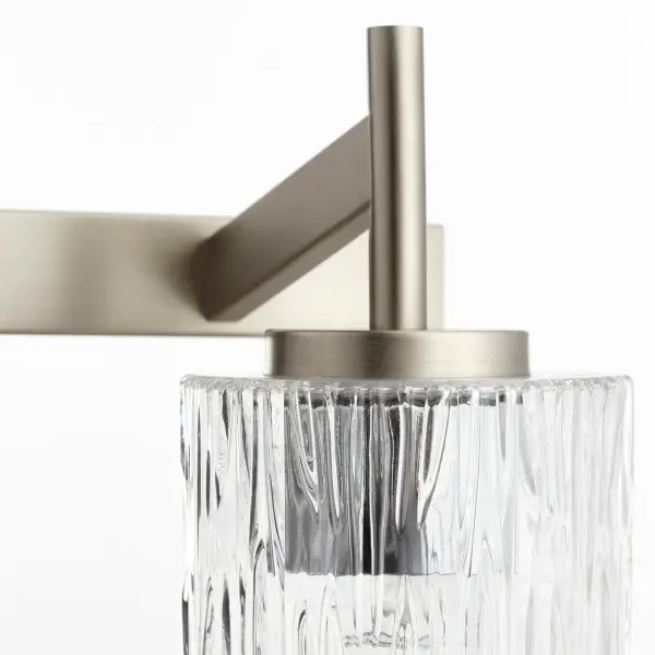 A modern 4-light vanity fixture featuring textured rectangular glass shades and a square backplate in satin nickel. Offers versatile styling with clean lines and contemporary appeal for bathroom spaces. - alternate view