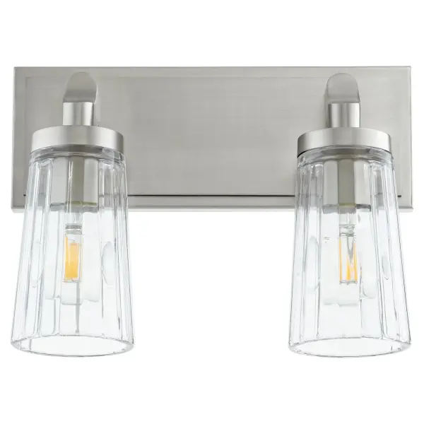 This two-light vanity fixture blends nostalgic charm with contemporary appeal through its satin nickel finish and clear fluted glass shades. Perfect for bathroom mirrors, it provides ambient lighting with a touch of glamour.