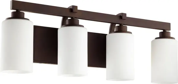The Lancaster 4-Light Vanity blends contemporary lines with traditional warmth through its oiled bronze finish and cylindrical glass shades. Slender curves and robust framing create a versatile fixture suitable for various bathroom styles.
