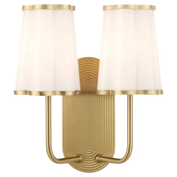 The Belinder 2-light wall sconce brings Tamara Day's signature relaxed luxury aesthetic to life with scalloped glass shades and a subtly ribbed backplate. The aged brass finish adds warmth and sophistication, perfect for elevating bathrooms, hallways, and bedrooms with modern yet timeless appeal. - alternate view