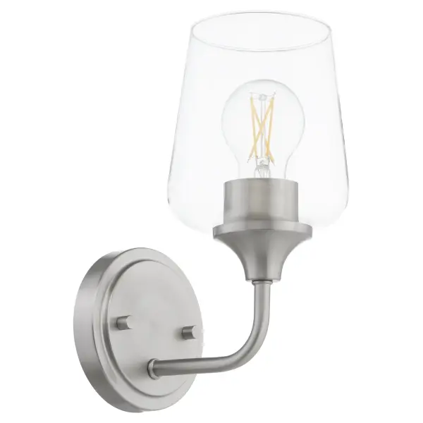 The Raymond wall sconce delivers uncomplicated style with its tapered clear glass shade and satin nickel finish. Part of the Main Street collection, it offers builder-friendly versatility at an accessible price point.