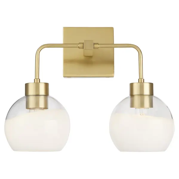 The Lacy 2-Light vanity fixture combines artisanal layered white glass shades with aged brass hardware for a sophisticated transitional look. Each hand-dipped shade creates unique flowing lines while slim rods and rounded corners soften the geometric square backplate. - alternate view