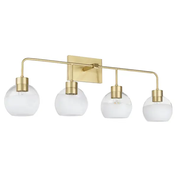The Lacy 4-Light vanity fixture combines artisanal layered white glass shades with aged brass hardware for a sophisticated transitional look. Each hand-dipped shade creates unique flowing patterns while slim rods and rounded corners soften the geometric square backplate.