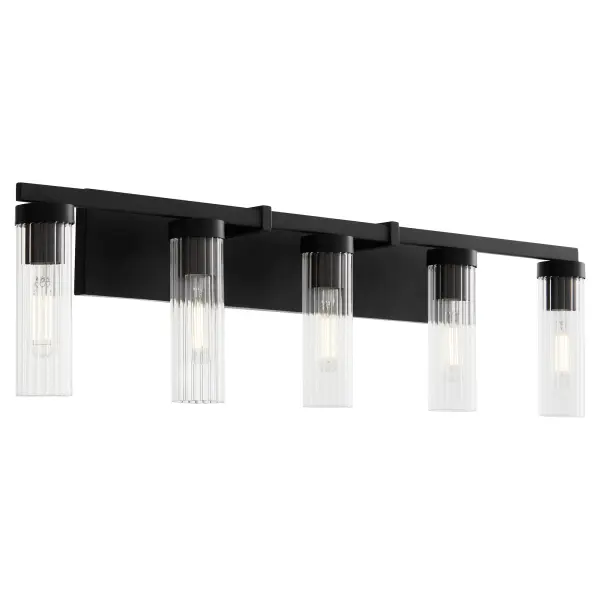 The Kilbey 5-Light Vanity combines industrial aesthetics with refined details through clear fluted glass shades and a sleek matte black finish. Perfect for larger bathrooms needing ample task lighting with style.