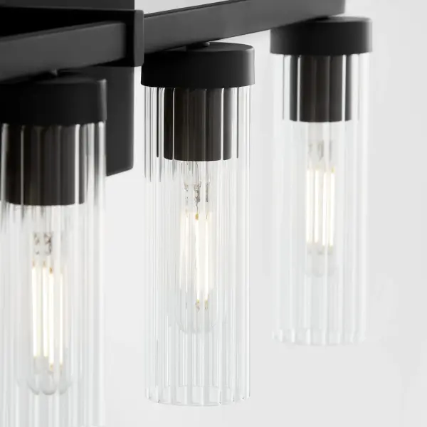 The Kilbey 5-Light Vanity combines industrial aesthetics with refined details through clear fluted glass shades and a sleek matte black finish. Perfect for larger bathrooms needing ample task lighting with style. - alternate view