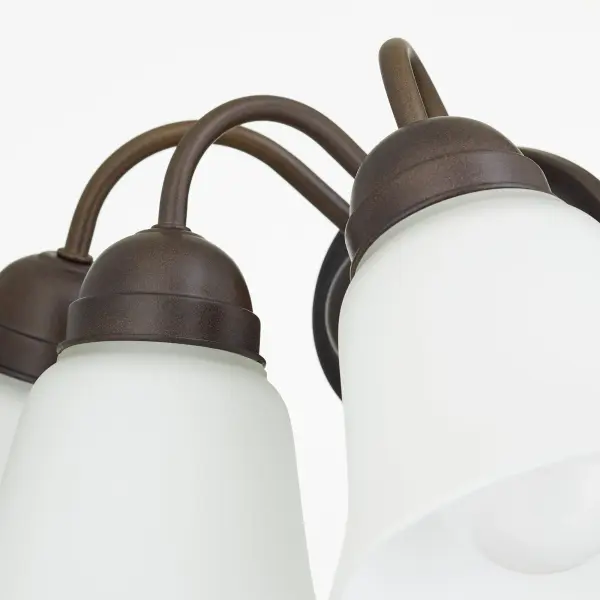 This 3-light wall sconce brings warmth and traditional elegance to any space with its graceful round elements and classic detailing. The rich oiled bronze finish adds depth and sophistication to hallways, bedrooms, and bathrooms. - alternate view