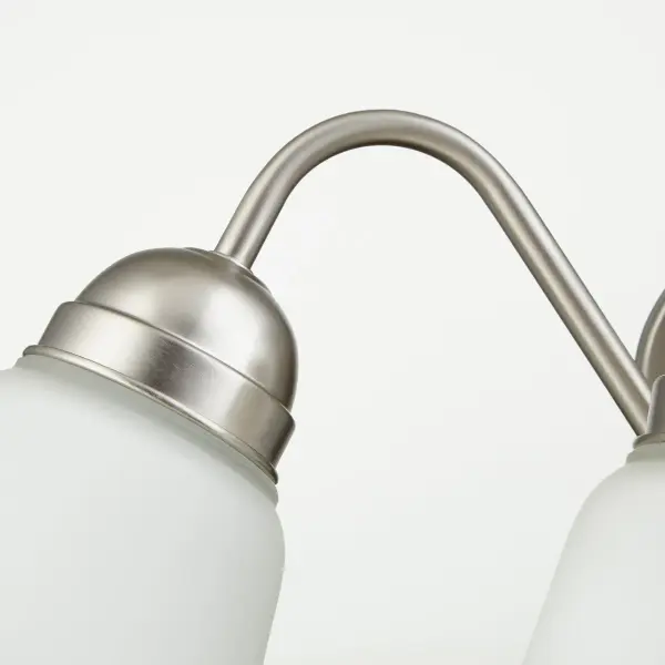 This 4-light wall mount fixture offers excellent illumination with a timeless satin nickel finish. Perfect for bathroom vanities or hallways, it provides ample light coverage while maintaining a clean, contemporary aesthetic. - alternate view