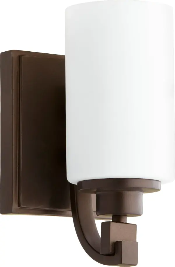 The Lancaster wall sconce bridges contemporary and traditional design with slender curves and cylindrical glass. Its oiled bronze finish and robust frame add warmth while maintaining clean lines, making it versatile for various spaces.