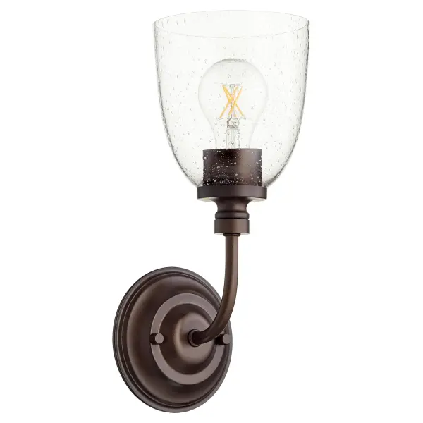The Rossington wall sconce bridges traditional and contemporary design with clean lines, soft curves, and a velvety oiled bronze finish. Clear seeded glass adds texture while the compact single-light design works beautifully in bathrooms, hallways, and entryways.